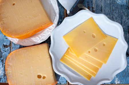 Cheese collection, Dutch ripe hard cheese made from cow milk in the Netherlands in piece and sliced close upの写真素材