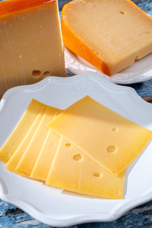 Cheese collection, Dutch ripe hard cheese made from cow milk in the Netherlands in piece and sliced close upの写真素材