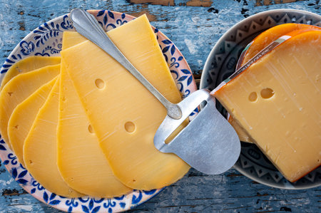 Cheese collection, Dutch ripe hard cheese made from cow milk in the Netherlands in piece and sliced close upの写真素材