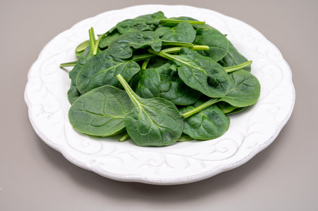 Fresh green baby Spinach leaves, diet and health concept, weight loss, washed spinach on ceramic plate, copy spaceの写真素材