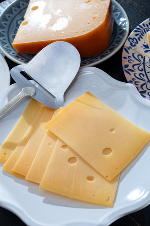 Cheese collection, Dutch ripe hard cheese made from cow milk in the Netherlands in piece and sliced close upの写真素材