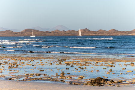 View Corralejo dunes, white sandy beach, blue water, Lobos and Lanzarote islands, north of Fuerteventura, Canary islands, Spainの写真素材
