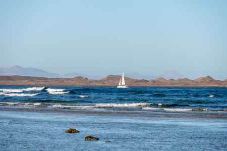 View Corralejo dunes, white sandy beach, blue water, Lobos and Lanzarote islands, north of Fuerteventura, Canary islands, Spainの写真素材