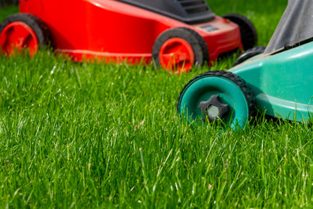 Seasonal maintenance works in garden, lawn movers in action, green grass cutting, lawn care, English lawn, garden keeping backgroundの写真素材