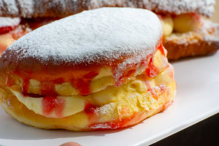 Dutch cuisine, fresh baked strawberry cake with cream and fresh fruits served in outdoor cafeの写真素材