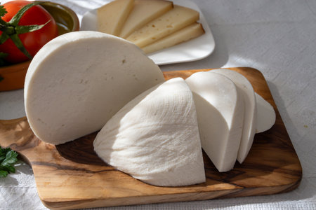 Freshly strained white soft goat cow sheep milk cheese, young Spanish cheese, close-upの写真素材