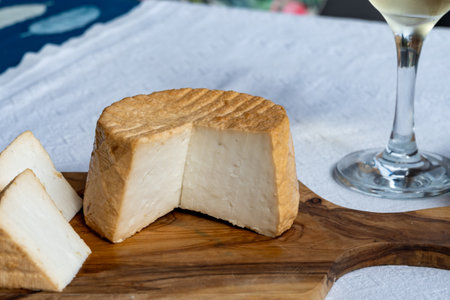 Cheese collection, piece of round fresh smoked Spanish goat cheese close upの写真素材