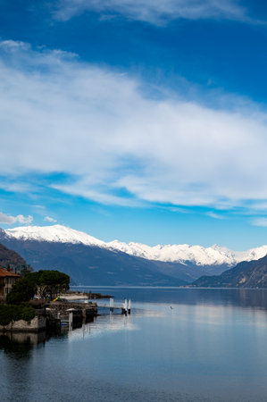 Driving car on road along shores of Lake Como in Northern Italy, spring sunny days, views of alpine mountains, water and villagesの写真素材
