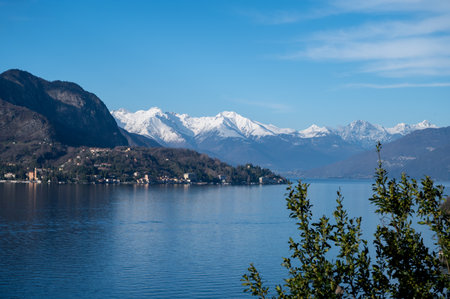 Driving car on road along shores of Lake Como in Northern Italy, spring sunny days, views of alpine mountains, water and villagesの写真素材