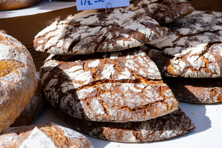 Artisanal organic fresh baked dark brown rye bread, bio grains bread close upの写真素材