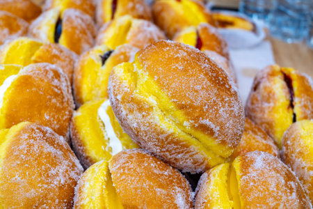 Stuffed Berlin balls pastries with cream or fruit jam for sale on food marketの写真素材