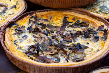 Tasty vegetarian food, french quiche savory tart with leek onion and cheddar cheese and mushrooms...