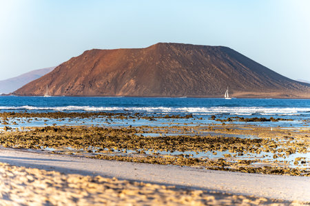 View Corralejo dunes, white sandy beach, blue water, Lobos and Lanzarote islands, north of Fuerteventura, Canary islands, Spainの写真素材
