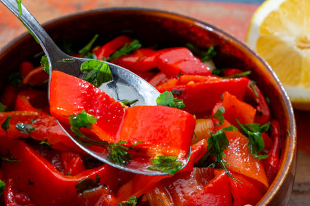 Grilled red peppers, sweet paprika salad with fresh garlic and parsley, tasty vegetablesの写真素材