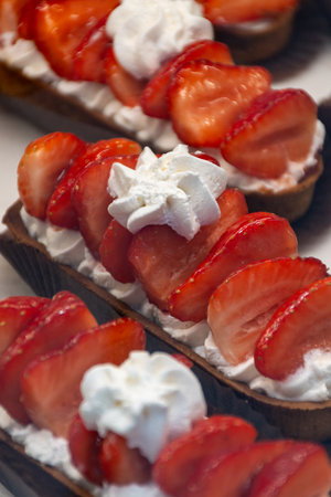 French cuisine, fresh baked iced strawberry cake with chantilly cream, sweet dessert close up