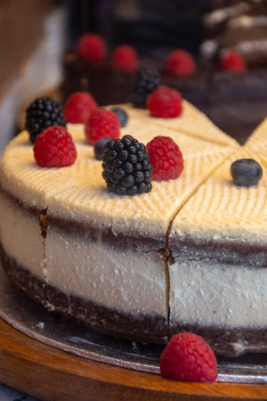 Red fruit sweet dessert cheesecake tart with fresh strawberries in bakery