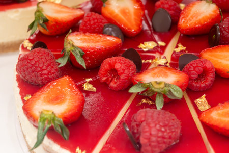 Red fruit sweet dessert cheesecake tart with fresh strawberries in bakery