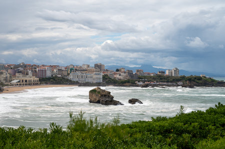 Panoramic view from lighthouse on cliffs, houses, sandy beaches of touristic Biarritz city, Basque Country, Bay of Biscay of Atlantic ocean, France, storm in Biarritzの写真素材