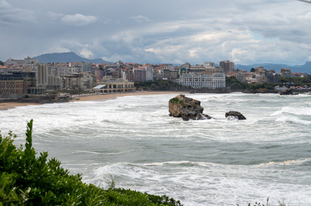 Panoramic view from lighthouse on cliffs, houses, sandy beaches of touristic Biarritz city, Basque Country, Bay of Biscay of Atlantic ocean, France, storm in Biarritzの写真素材