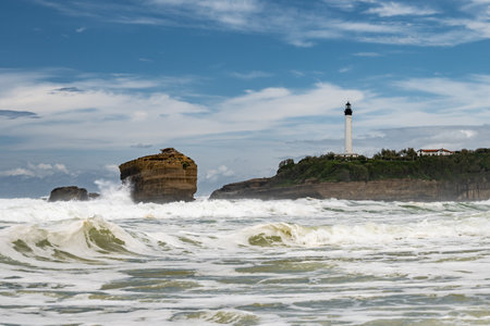 Panoramic view from Grand Plage on cliffs, lighthouse, sandy beaches of touristic Biarritz city, Basque Country, Bay of Biscay of Atlantic ocean, France in stormの写真素材
