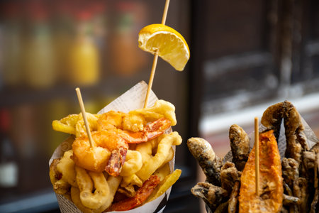 Italian street food, variety of catch of the day fish deep fried in paper cone, seafood