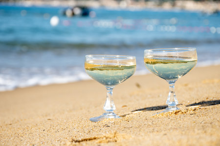 Summer time on French Riviera, two coupe glasses of champagne cremant sparkling wine on Pampelonne sandy beach near Saint-Tropez in sunny day, Var department, vacation in Franceの写真素材