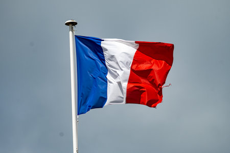 Blue red white french flag on roof and sky on backgroundの写真素材