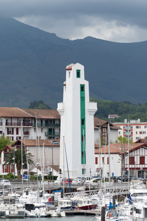 White houses, lighthouse and port of old part of Ciboure and Saint-Jean-de-Luz on Basque coast, famous resort, known for beautiful architecture, sandy beaches, cuisine, South of France, Basque Countryの写真素材