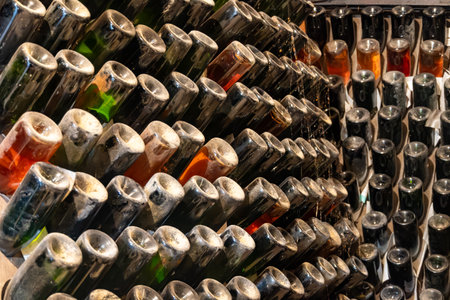 Visit of old champagne caves in grand cru wine producer small village Cramant, Champagne, France. Dusty champagne bottles on pupitre riddling racksの写真素材