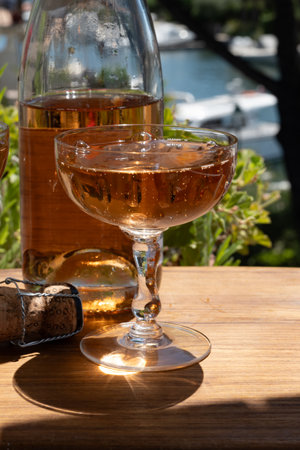 French brut rose champagne sparkling wine in coupe glasses in yacht harbor of Port Grimaud near Saint-Tropez, French Riviera vacation, Var, France is summerの写真素材