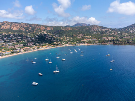 Panoramic view from above on blue Mediterranean dea, sandy beach of Agay town, summer vacation destination near Esterel red mountains, French Riviera, Provence. Franceの写真素材