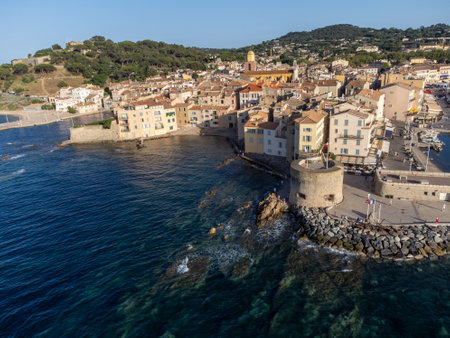 Aerial view on bays, beaches, old colorful houses of famous Saint-Tropez town on French Riviera at sunset, Var, Provence, France, summer vacation destinationの写真素材