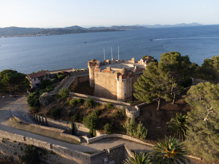Aerial view on bay, hills, old citadel fort, colorful houses of famous Saint-Tropez town on French Riviera at sunset, Var, Provence, France, summer vacation destinationの写真素材