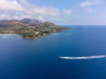Panoramic view from above on blue Mediterranean dea, sandy beach of Agay town, summer vacation destination near Esterel red mountains, French Riviera, Provence. Franceの写真素材