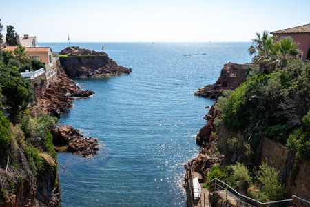 Views along Corniche d'Or or Corniche de l'Esterel beautiful coastal road, crystalline blue sea and sky combined with reddish color of Massif de l'Esterel mountains, travel destination in France, French Rivieraの写真素材
