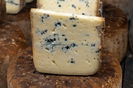 Pieces of tasty Blue Basque Fume smoked sheep cheese produced in south-western France, Northern Basque Country on local farmers market in Biarritzの写真素材