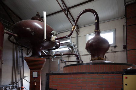 Double distillation process of cognac spirits in Charentias copper alembic still pots and boilers in...