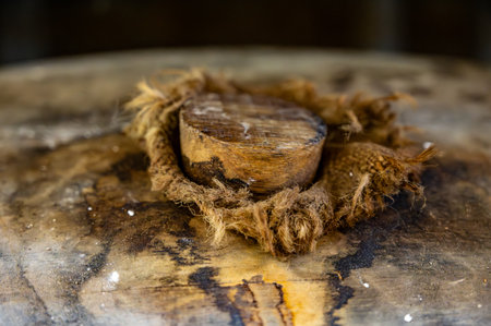 Aging process of cognac spirit in old dark French oak barrels in cool cellar in distillery house, white wine region, Charente, Segonzac, Franceの写真素材