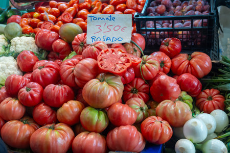 Vegetables of Spain, large farmers organic ripe rose tomatoes from Navarra on local market, tomate rosado means pink tomatoesの写真素材