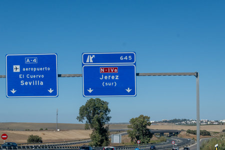 Driving car or family camper in summer, road signs and directions Sevilla, Jerez, Cadiz, no traffic jam on touristic road in Andalusia, Spainの写真素材