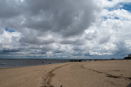 Walking on beach promenade in sunny Arcachon, vacation destination town on Atlantic coast with beautiful parks, villas, streets and sandy beach and pine trees, Franceの写真素材