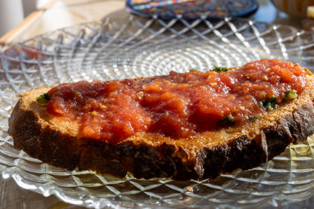 Traditional andalusian breakfast on roof patio with bread toasts, fresh ground tomatoes sauce and olive oil, Sevilla, Andalusia, south of Spainの写真素材