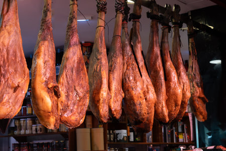 Daily farmers market in Triana, Seville, different ham jamon serrano legs, cheese and sausages to...