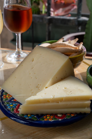 Cheese collection, Spanish matured cheese and onion chutney close up in sunlights, Andalusian style,...