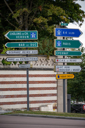 Roundabout with many directions to different cities, green and blue road signs in Champagne sparkling wine making town Reims, tourists destination in France in summerの写真素材