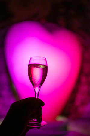 Celebration, night or beach club with party lights in France or Monaco and glass of champagne sparkling wine, dancing with wine for wedding eventの写真素材