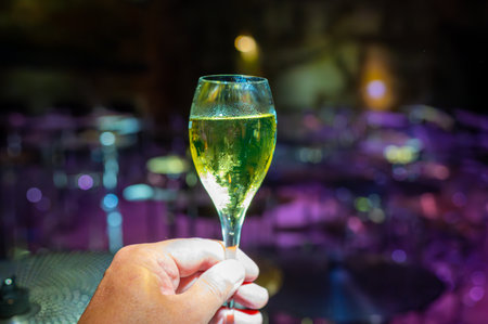 Celebration, night or beach club with party lights in France or Monaco and glass of champagne sparkling wine, dancing with wine, wedding eventの写真素材