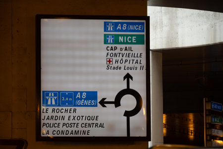 Driving car on narrow streets of Monaco, road signs with directions to Menton, Nice, traffic jam and parking problems in Monacoの写真素材
