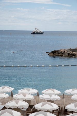 Sandy beach in Monaco, Monte-Carlo Lavrotto beach with clear sea water and beach cafe and...