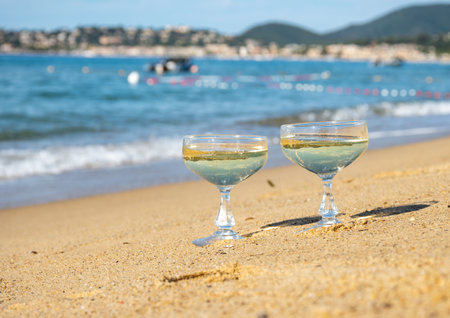 Summer time on French Riviera, two coupe glasses of champagne cremant sparkling wine on Pampelonne sandy beach near Saint-Tropez in sunny day, Var department, vacation in Franceの写真素材